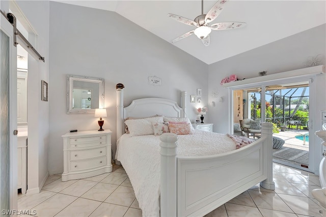 bedroom with access to exterior, ceiling fan, light tile patterned floors, a barn door, and lofted ceiling