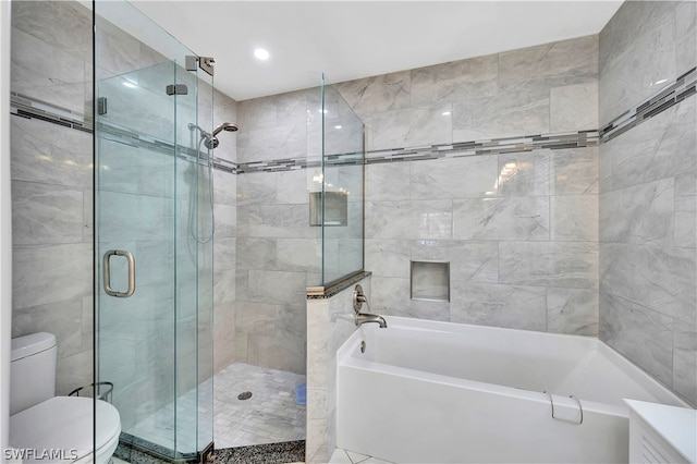 bathroom with toilet and shower with separate bathtub