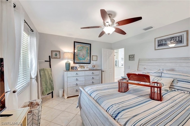 bedroom with ceiling fan and light tile patterned flooring