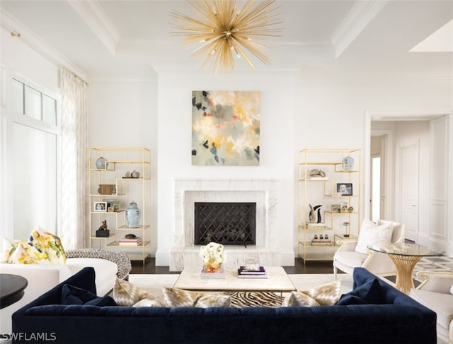 living room with ornamental molding, hardwood / wood-style floors, and a high end fireplace