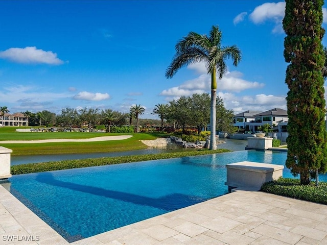 view of swimming pool with a yard and a patio