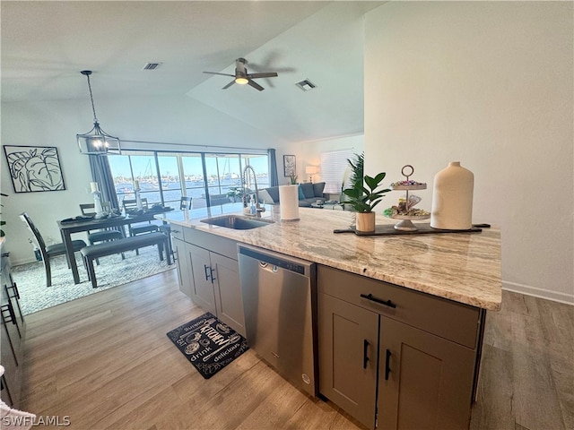 kitchen with ceiling fan with notable chandelier, dishwasher, sink, and light wood-type flooring