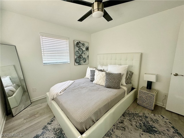 bedroom with light hardwood / wood-style floors and ceiling fan