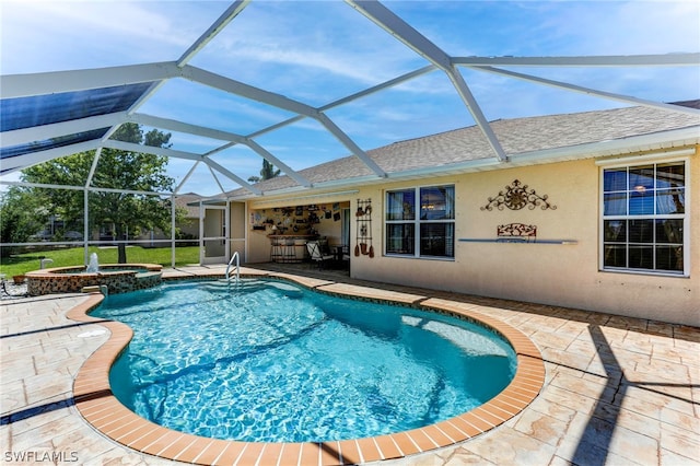 view of swimming pool with glass enclosure, a patio area, and an in ground hot tub