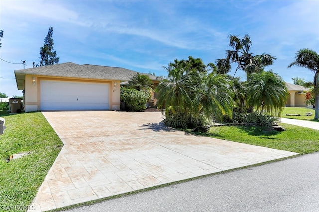 view of front of house featuring a garage and a front lawn