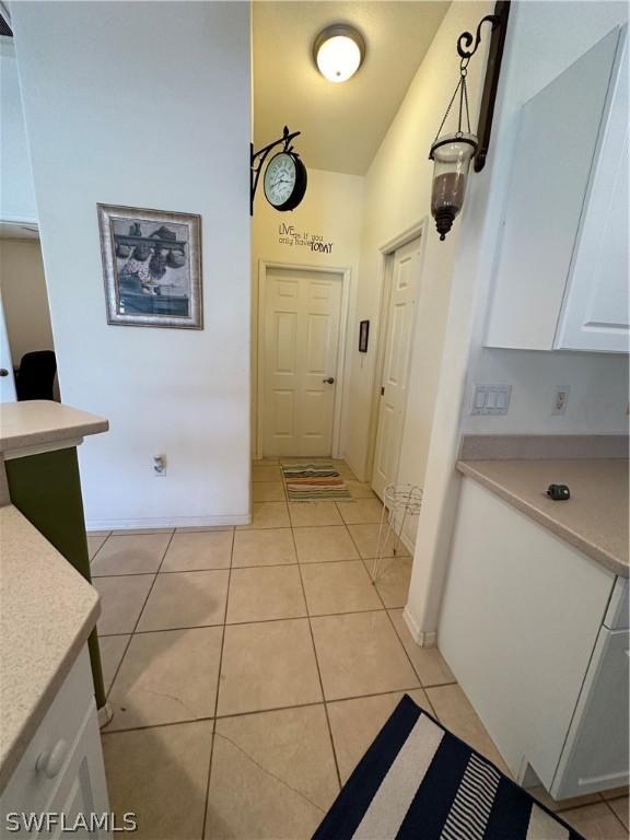 hall with light tile patterned flooring