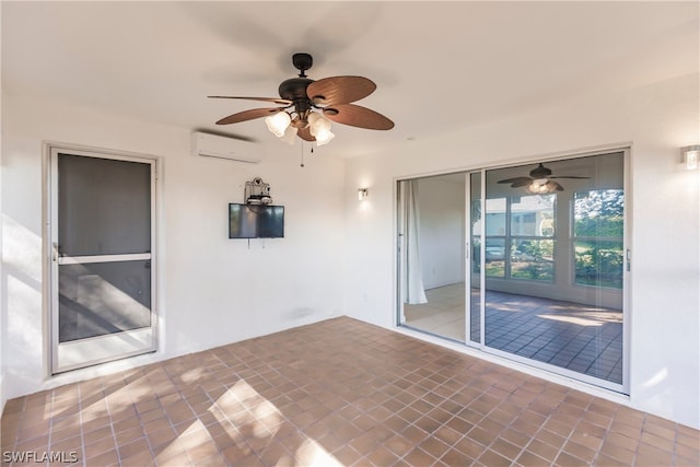 tiled spare room with an AC wall unit and ceiling fan