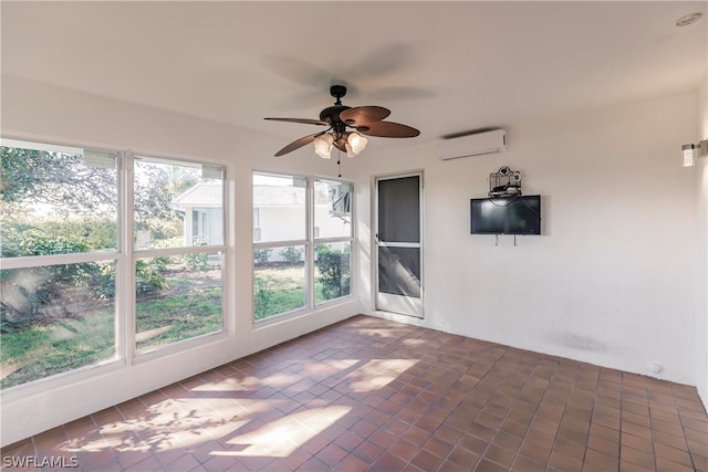 unfurnished sunroom featuring ceiling fan and a wall unit AC