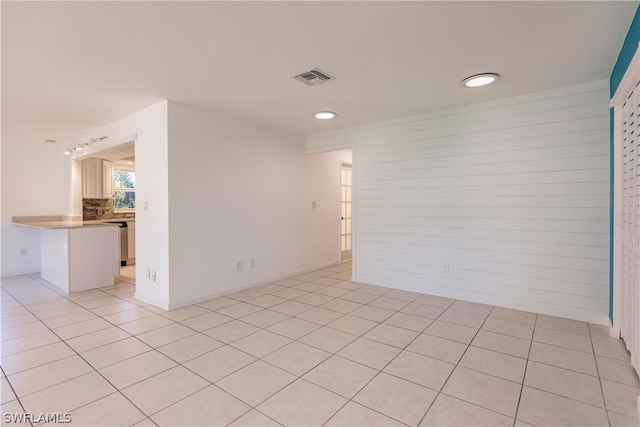 spare room with light tile floors