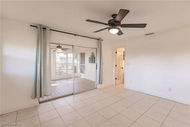 unfurnished room with ceiling fan and light tile floors