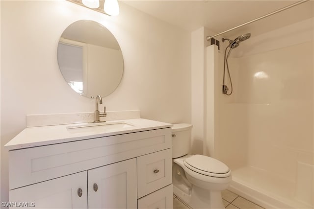 bathroom featuring a shower, toilet, tile flooring, and vanity