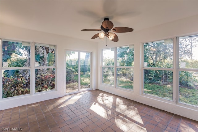 unfurnished sunroom featuring ceiling fan