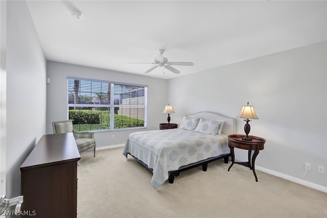 bedroom with ceiling fan and light colored carpet