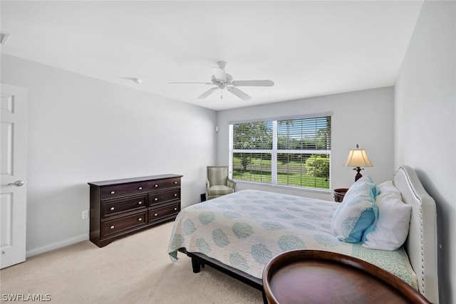 bedroom with light colored carpet and ceiling fan