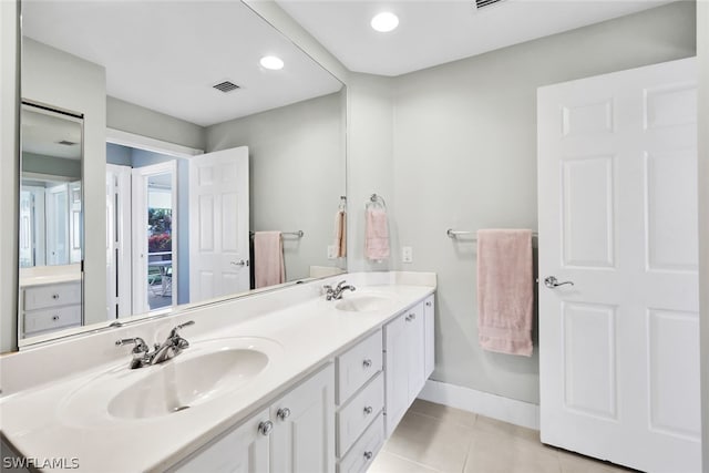 bathroom with tile patterned flooring and vanity