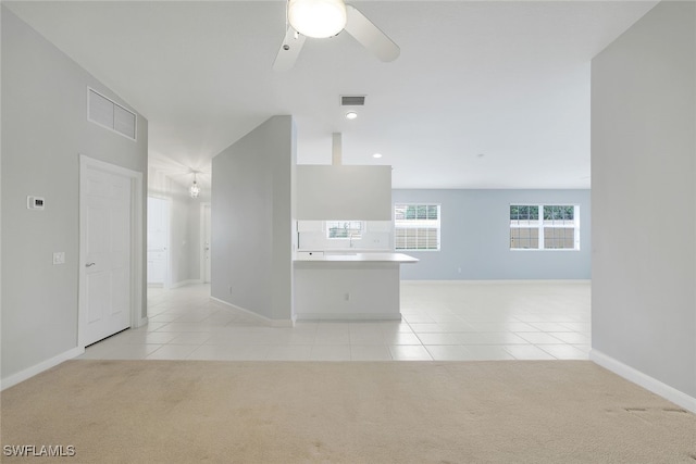 unfurnished living room with ceiling fan and light colored carpet