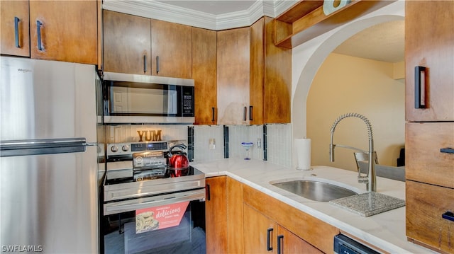 kitchen with tasteful backsplash, stainless steel appliances, sink, and light stone counters