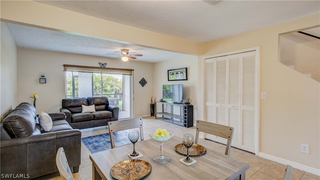 tiled living room with a textured ceiling and ceiling fan