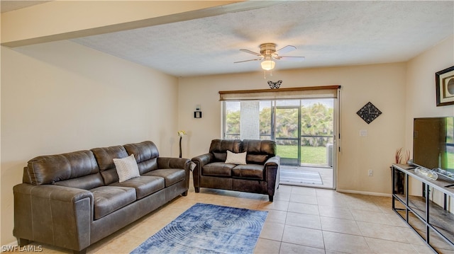 tiled living room featuring ceiling fan and a textured ceiling