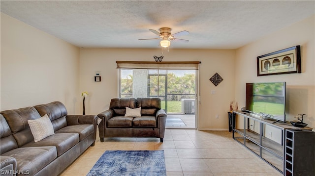 living room featuring light tile floors, a textured ceiling, and ceiling fan