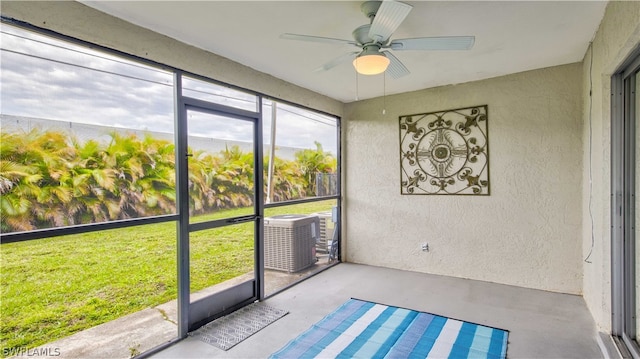 unfurnished sunroom with ceiling fan