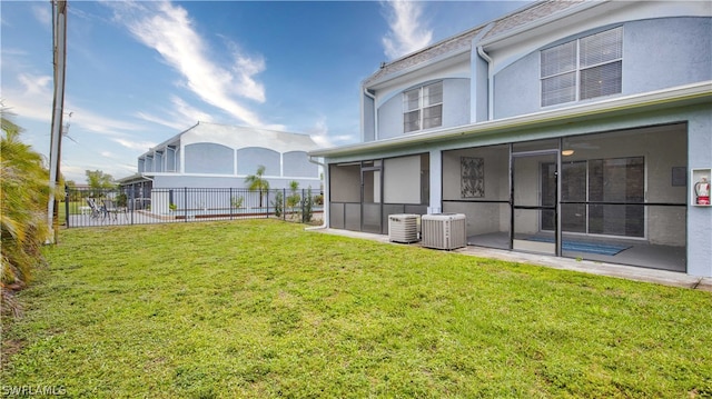 view of yard with a sunroom, central AC, and a patio