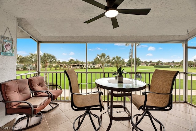 sunroom featuring ceiling fan and a healthy amount of sunlight