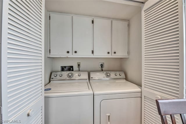 laundry area with washing machine and dryer, hookup for an electric dryer, and cabinets