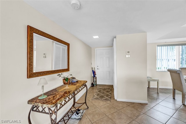 hall featuring light tile patterned flooring