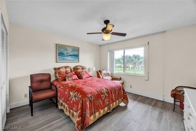 bedroom with a closet, ceiling fan, and light wood-type flooring