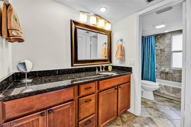 full bathroom featuring shower / tub combo, vanity, and toilet