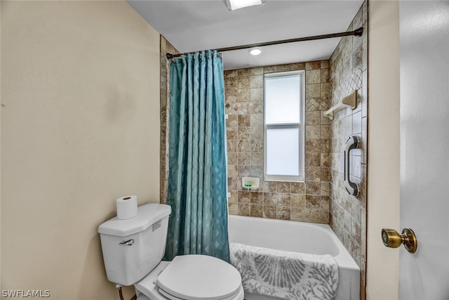 bathroom featuring shower / bath combination with curtain and toilet