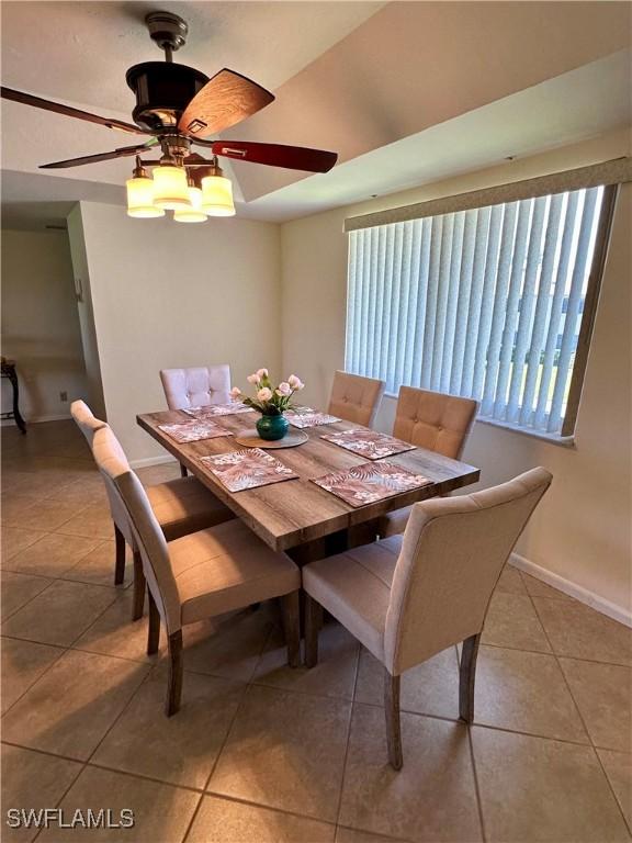 tiled dining area with ceiling fan