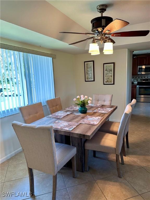 tiled dining area featuring ceiling fan