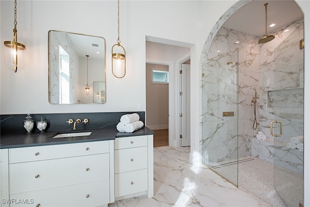 bathroom featuring vanity and a shower with shower door