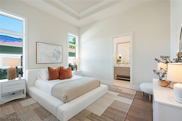 bedroom featuring hardwood / wood-style floors and connected bathroom