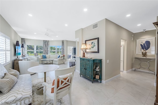 tiled living room featuring ceiling fan