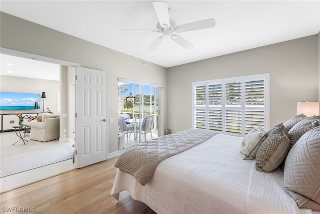 bedroom with access to outside, ceiling fan, and light hardwood / wood-style flooring