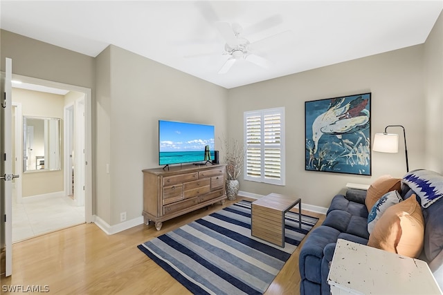 living room featuring ceiling fan and light wood-type flooring