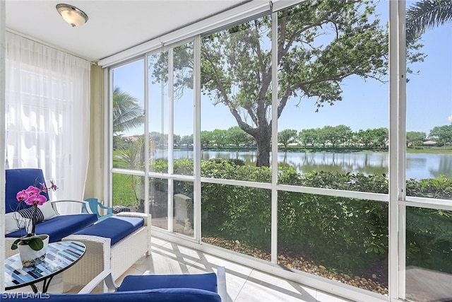 sunroom / solarium featuring a water view