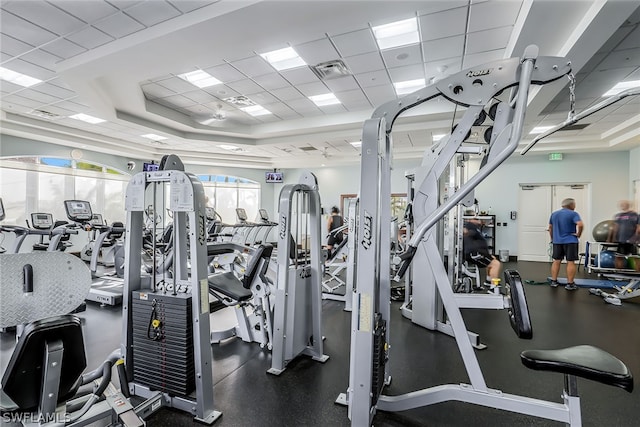 workout area with a raised ceiling and a drop ceiling