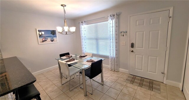 tiled dining room featuring an inviting chandelier