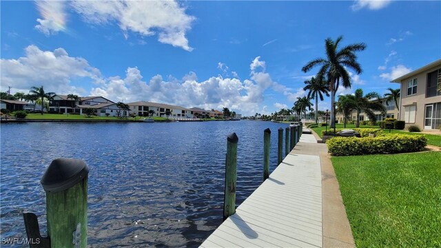 dock area featuring a yard and a water view