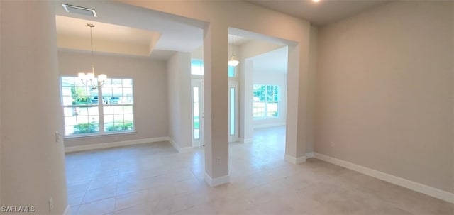 unfurnished room featuring light tile patterned floors and a notable chandelier