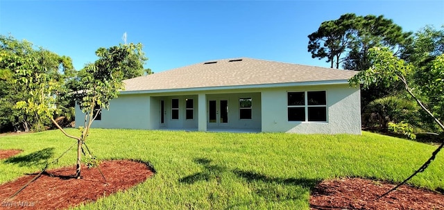 rear view of property with a lawn