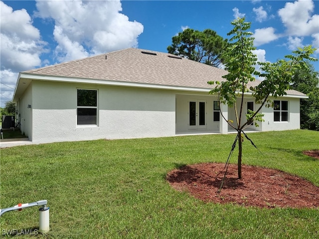 back of property featuring a lawn