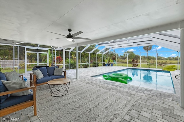 view of swimming pool featuring an outdoor hangout area, a lanai, a patio area, and ceiling fan