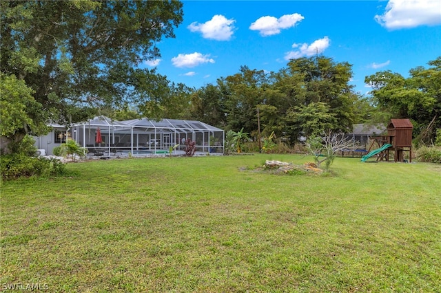 view of yard featuring a playground, a lanai, and a swimming pool