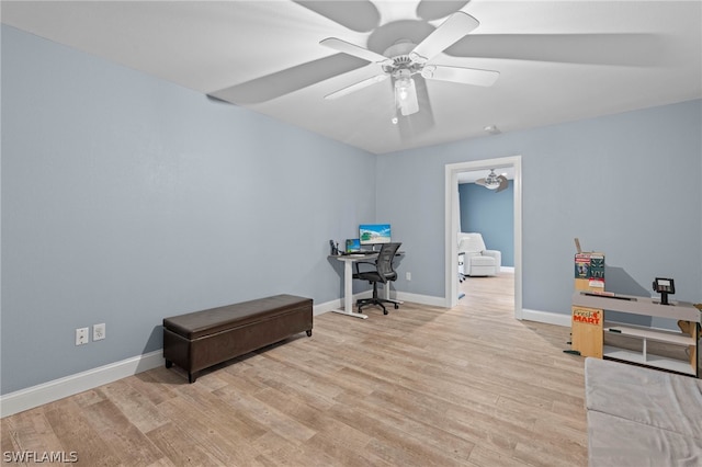 home office with ceiling fan and light hardwood / wood-style floors