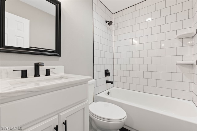 full bathroom with toilet, tiled shower / bath combo, and vanity